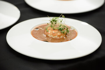 Tomato gazpacho soup served with burrata cheese. Tasty appetizing summer tomato soup