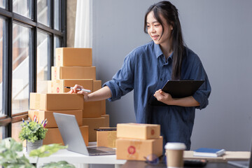 Small business aspiring young asian entrepreneur SME, small and medium business freelance worker working in a home office.SME online business ideas.