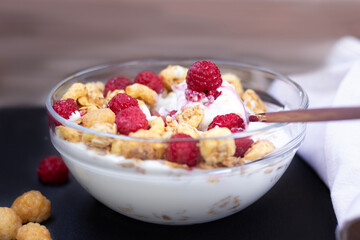 Healthy food yogurt with granola and raspberries