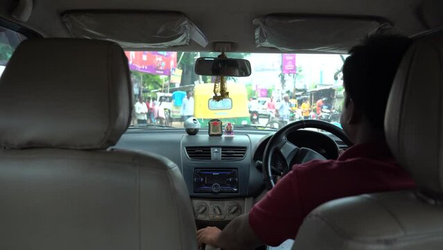 Navigating through India's bustling roads, a driver encounters a symphony of vehicles, honks, and vibrant chaos, skillfully maneuvering to reach their destination.