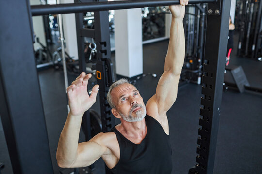 Determined man exercising in health club