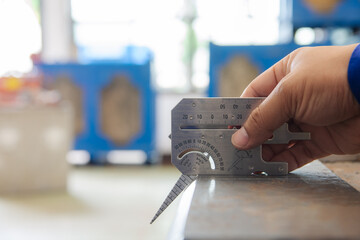 QC inspector measure the bevel angle with Multi Welding Gauge. Welding Gauge is a measuring tool used to measure the angle or height of the welding of the objects as required by braced with the object