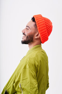 Happy man wearing knit hat against white background