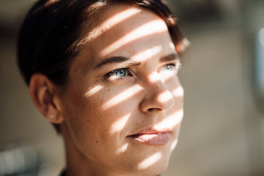Thoughtful businesswoman with sunlight on face