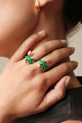 Close-up of woman hand touching her neck and showing rings. Horizontal mock-up