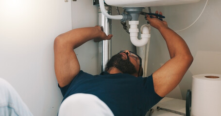 Plumber black man, kitchen and sink maintenance with tools, focus and pipe repair for drainage in...
