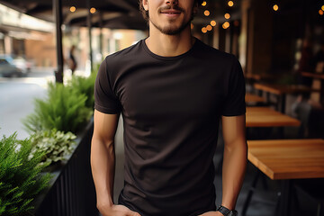 Obraz premium A Young Man Dons a Bella Canvas Black T-Shirt and Jeans, Enjoying a Relaxing Day at a Cozy Restaurant, Featuring a T-Shirt Design Template and Print Presentation Mockup. created with Generative AI