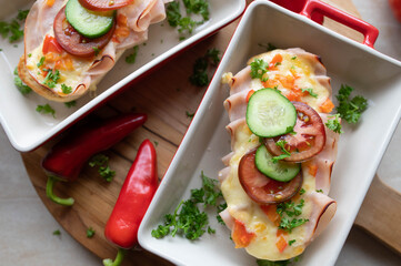 Turkey baguette with cheddar cheese and vegetables. Open faced