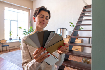 Woman finalizing color from sample swatch at home