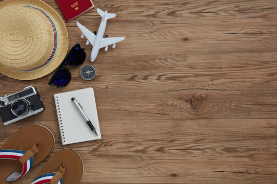 top view of travel gadgets on wooden  background for travel concept