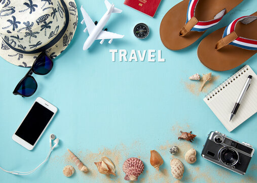 top view of travel gadgets on blue background for travel concept