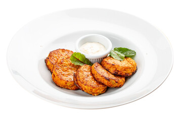 Pumpkin cutlets with white sauce. Vegetarian dish. Isolated image on a white background.