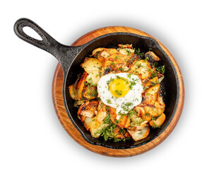 Fried potatoes with wild mushrooms and egg. In a cast iron skillet. Isolated image on white background.