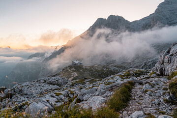 mountain landscape with cottage at sunset