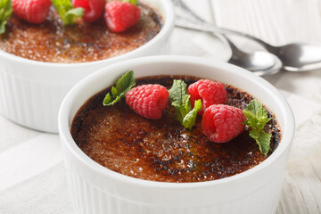 Traditional Chocolate creme brulee dessert with caramelized brown sugar close-up in a ramekin on the table. Horizontal