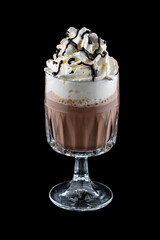 Coffee drink with cream and chocolate syrup in original glass tumbler. Isolated on a dark background