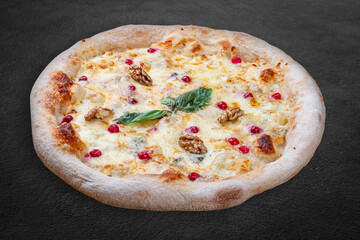 Pizza Four Cheese with smoked suluguni, gorgonzola, mozzarella, mountain ash, walnuts, honey, basil. Neapolitan round pizza on dark background