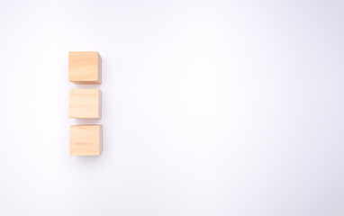 Three wooden cubes are on a white background.