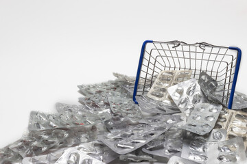 decorative shopping basket with empty pill boxes against the background of empty pill boxes