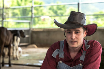 Young cowboy in cow farming