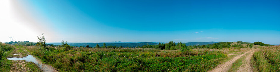 Wind turbine for alternative energy in mountain landscape with clear space background. The concept of clean energy, eco-energetics of the wind.