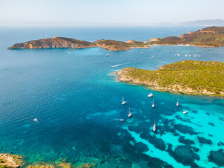 Fototapeta na wymiar Top panoramic view of small boats that stand off the coast of Sardinia with perfectly clear water. Italy Sardinia