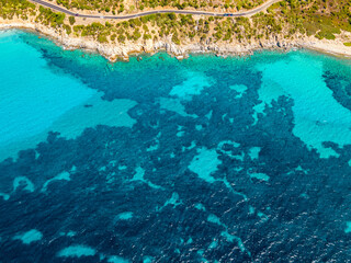 Drone flight over the crystal clear sea off the coast of Italian Sardinia. Tourist destination in Europe