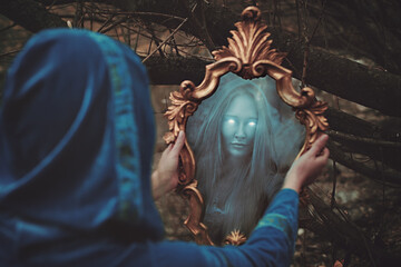 Mystical reflection of a forest witch. Mirror magic - 644386530