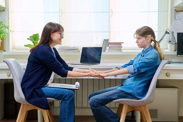 Sad teenage girl at therapy meeting with psychologist