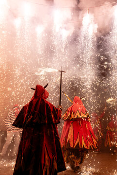 Anonymous dancers with fireworks celebrating Correfoc
