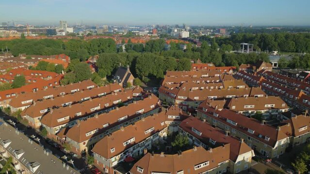 Backward orbit of Vogelbuurt in Amsterdam Noord with city center in skyline