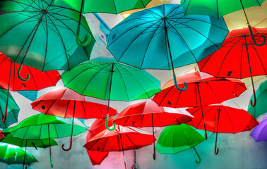 Fototapeta na wymiar open umbrellas to color a gray rainy autumn