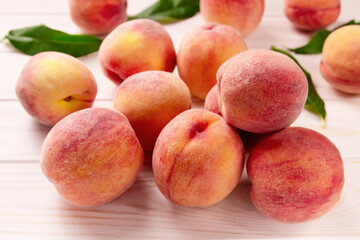 Fototapeta na wymiar Fresh peaches on a wooden table.