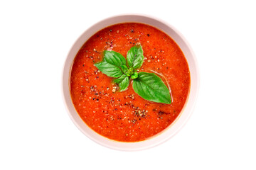 Tomato cream soup with basil and spices on a white background