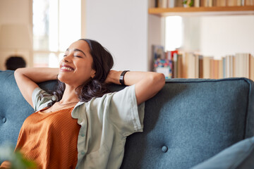 Smiling multiethnic woman relaxing at home with copy space - obrazy, fototapety, plakaty