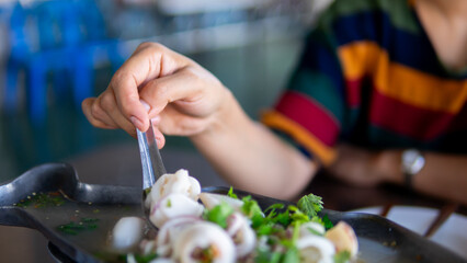 Close up women eating seafood