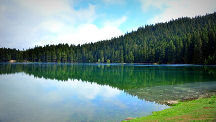 Fototapeta na wymiar Black Lake is a lake located 3 km from the town of Žabljak in northern Montenegro. It is a glacial lake, located on the Durmitor mountain, at an altitude of 1,416 m. 