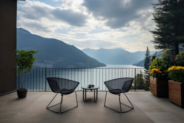 Fototapeta premium Picturesque view from the terrace, located on the seafront, surrounded by lush greenery, overlooking a quiet bay.