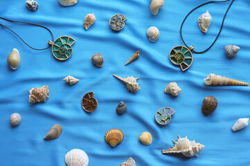 pendants in the form of shells on a blue background with marine attributes