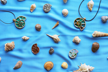 pendants in the form of shells on a blue background with marine attributes