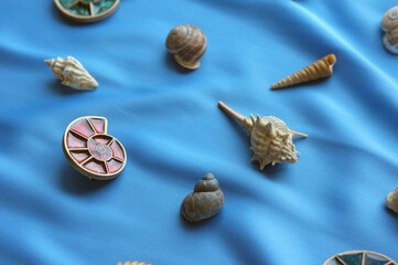 pendants in the form of shells on a blue background with marine attributes