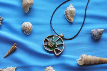 pendants in the form of shells on a blue background with marine attributes