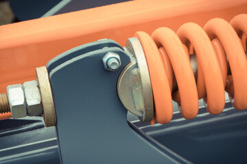 Steel orange spring as part of agricultural machine. Technology