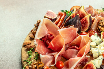 Prosciutto with figs and cheese. Dinner or aperitivo party concept. Restaurant menu, dieting,...