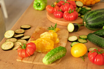 Woman using a knife cutting fresh raw vegetables. Tomatoes, cucumbers being sliced on a wooden board. Cooker at home making a healthy veggie meal. Chopping ingredients for preparing vegetarian dish 4K