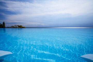 Beautiful landscape with an infinity pool by the sea.