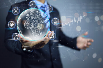 A businessman hold a globe in his hand, symbolizing contact or connection in business and using technology to communicate with his team or partners to collaborate and find new idea to customer need
