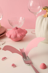 Table setting for Halloween in white and pink tones