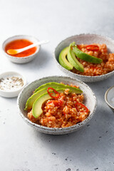 Spicy rice with avocado and chili sauce