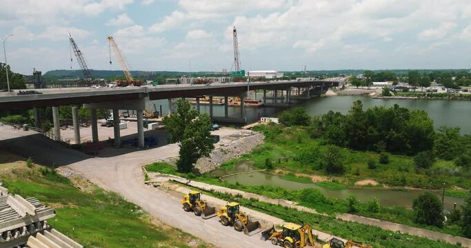 Cranes At Bridge Construction Site Across Arkansas River In Little Rock, Arkansas, USA. wide aerial
